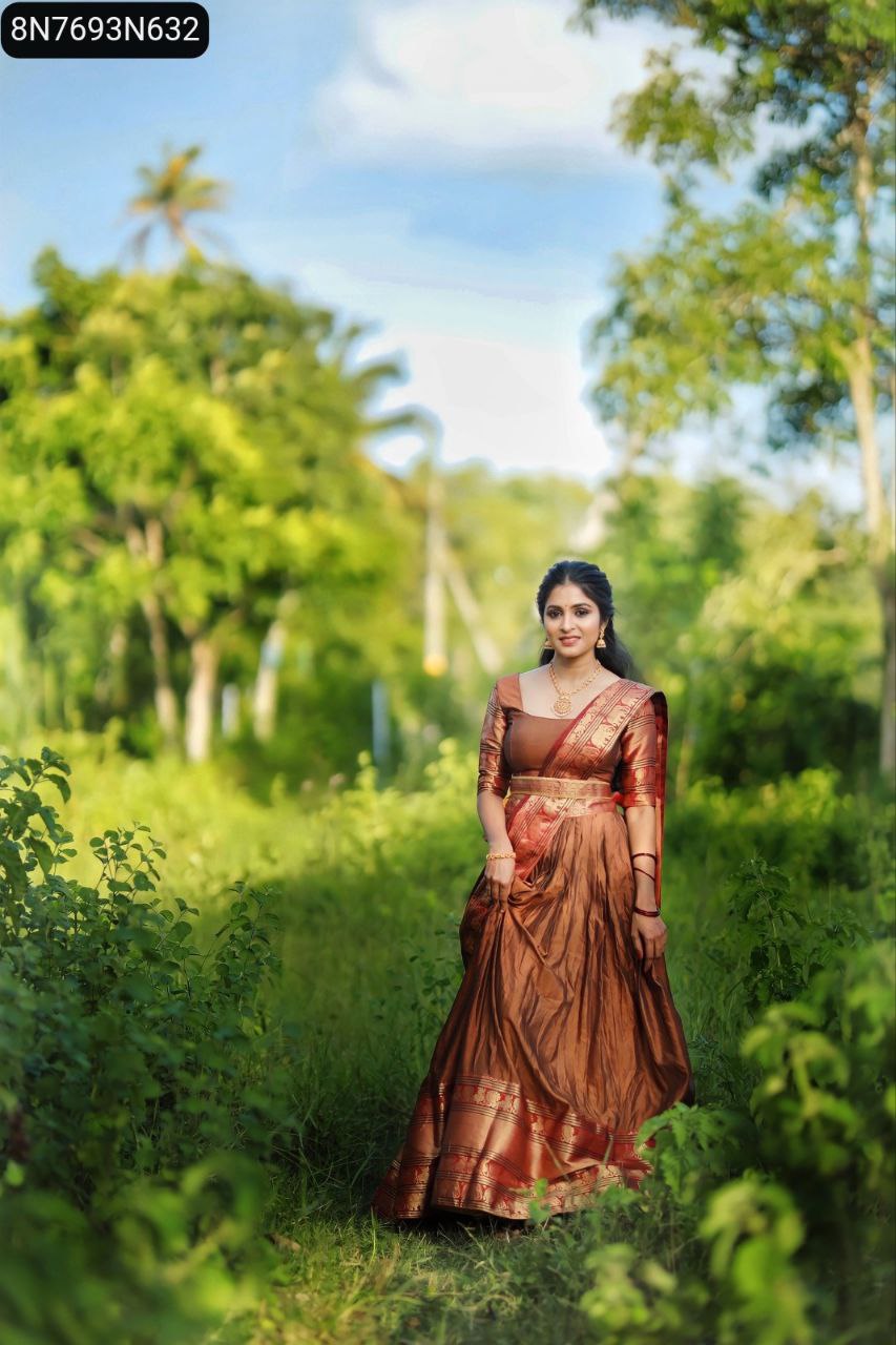 TRENDBUY Bronze Narayan Pet Cotton Lehenga Choli full body view, model standing gracefully in a lush green field, showcasing Zari weaving.