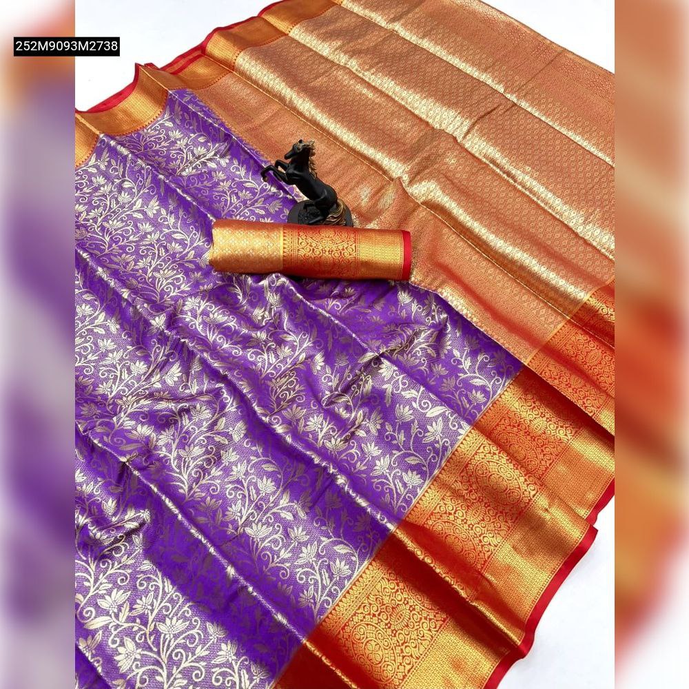 Top-down view of a folded TRENDBUY lavender Kanjivaram semi silk saree with gold and silver zari floral patterns and a wide red-gold contrast border, alongside a matching rolled blouse piece and a black horse figurine.