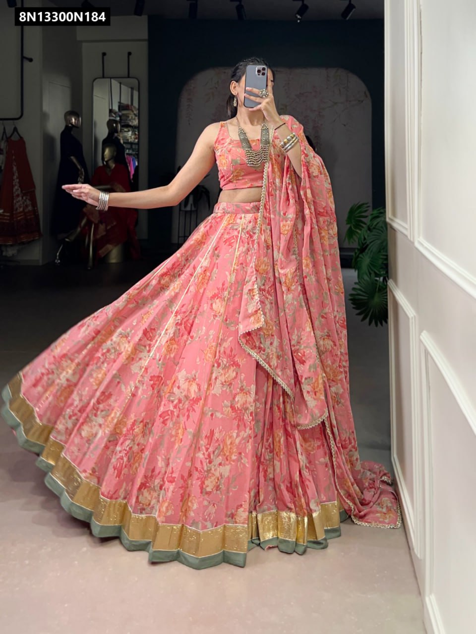 TRENDBUY Pink Chiffon Floral Print Lehenga Choli set with Foil Print and Gotta Patti lace, model twirling to display the magnificent 8-meter flair.