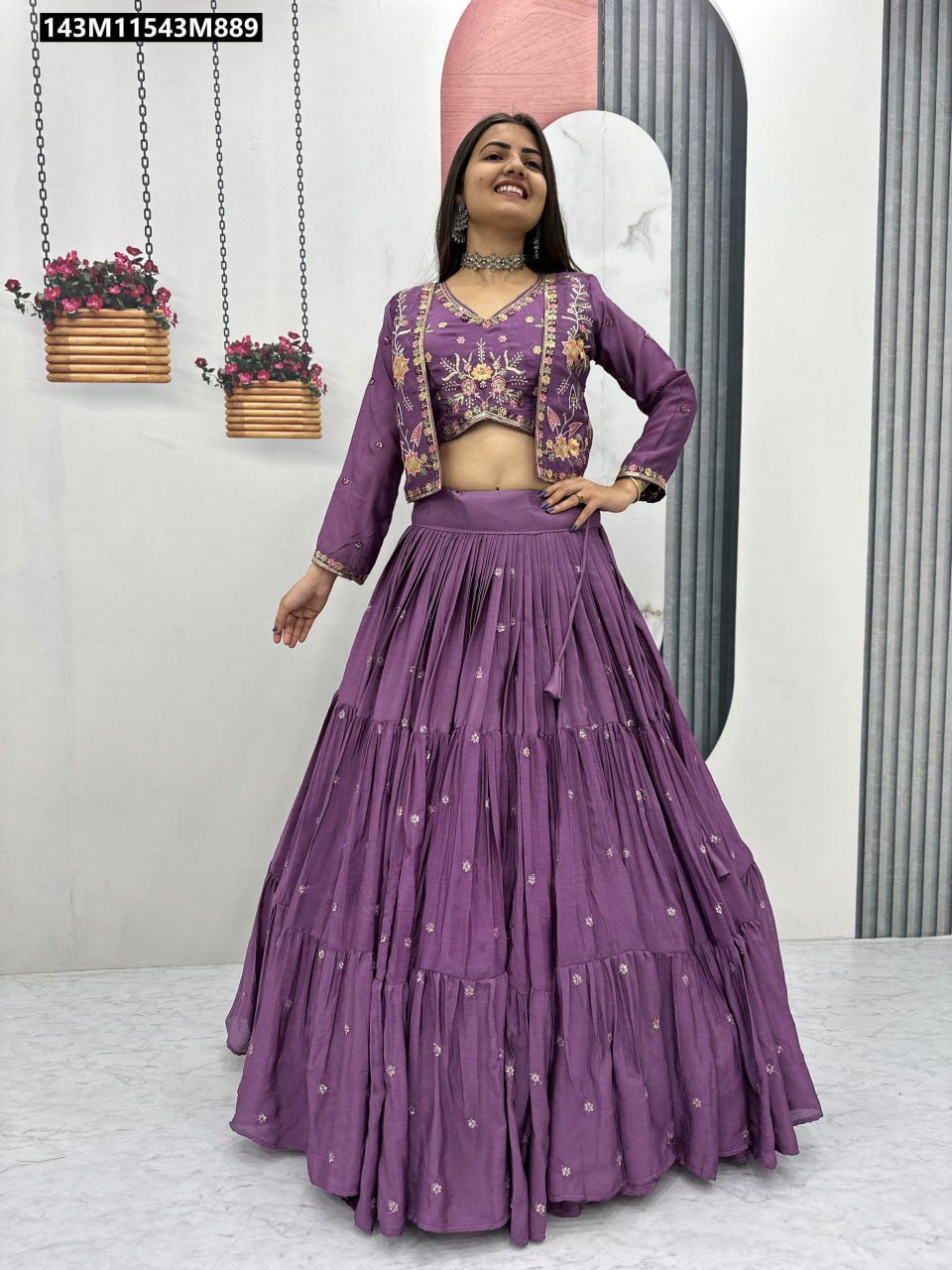 Model posing confidently in a full-body shot of TRENDBUY purple Chinon lehenga choli and richly embroidered jacket.