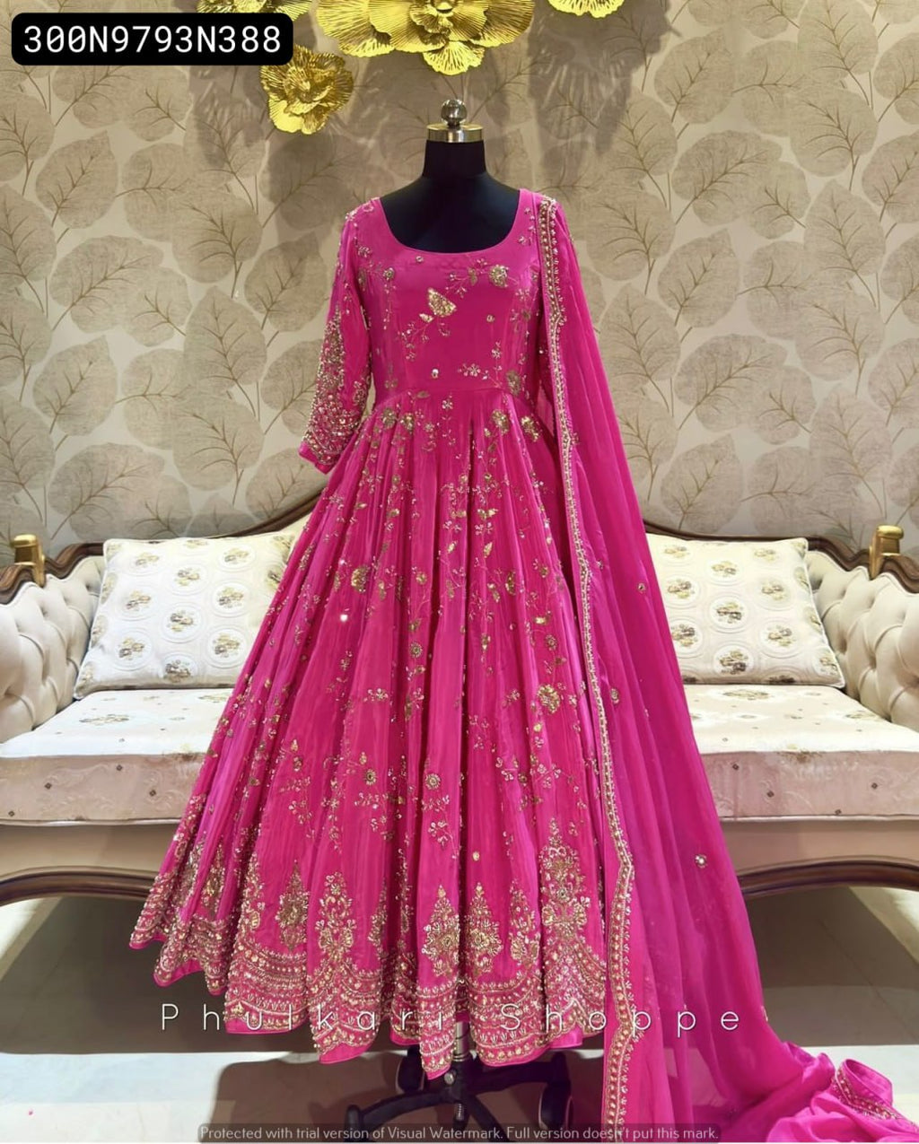 Mannequin displaying the full length of the TRENDBUY Fuchsia Pink Cinon Silk Anarkali Gown Set, showcasing its elegant drape, intricate gold embroidery, and overall silhouette.