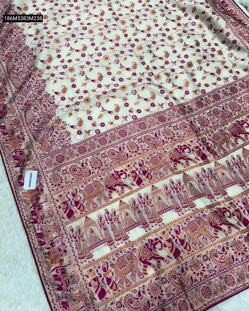 TRENDBUY Banarasi Soft Silk Saree spread out, featuring a cream base with a vibrant magenta pink and gold Zari work border, adorned with traditional elephant figures and intricate floral patterns.