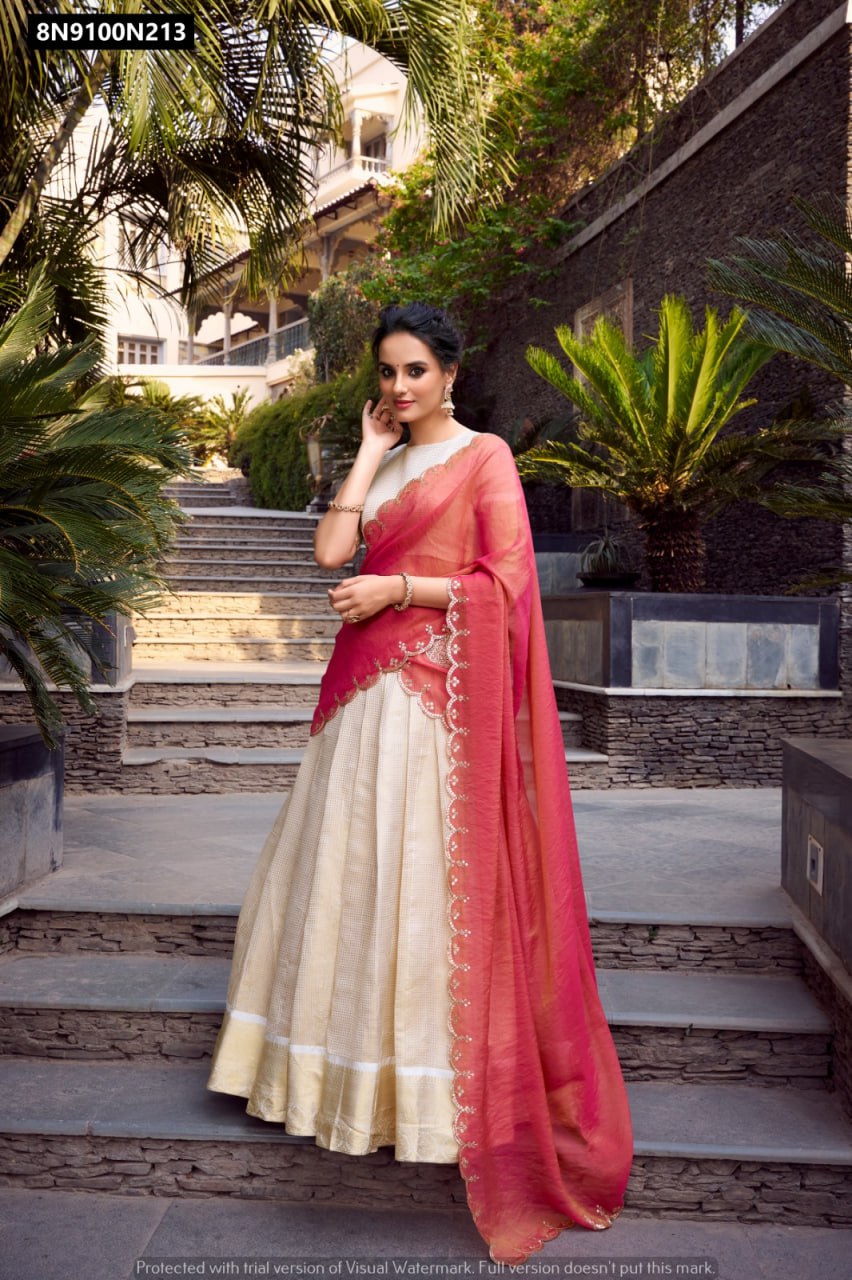 Main image: Full length view of the TRENDBUY Cream & Red Jacquard Chex Lehenga Choli set, featuring a model gracefully standing outdoors, highlighting the lehenga's flair and dupatta's detailed embroidery.