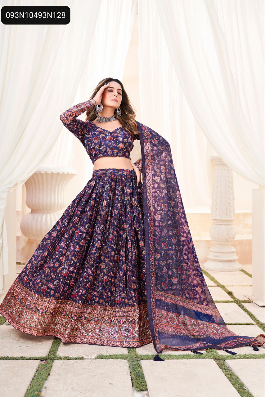 TRENDBUY Navy Blue Chinon floral printed lehenga choli with Mukesh work and patterned border, modeled full body against white pillars.