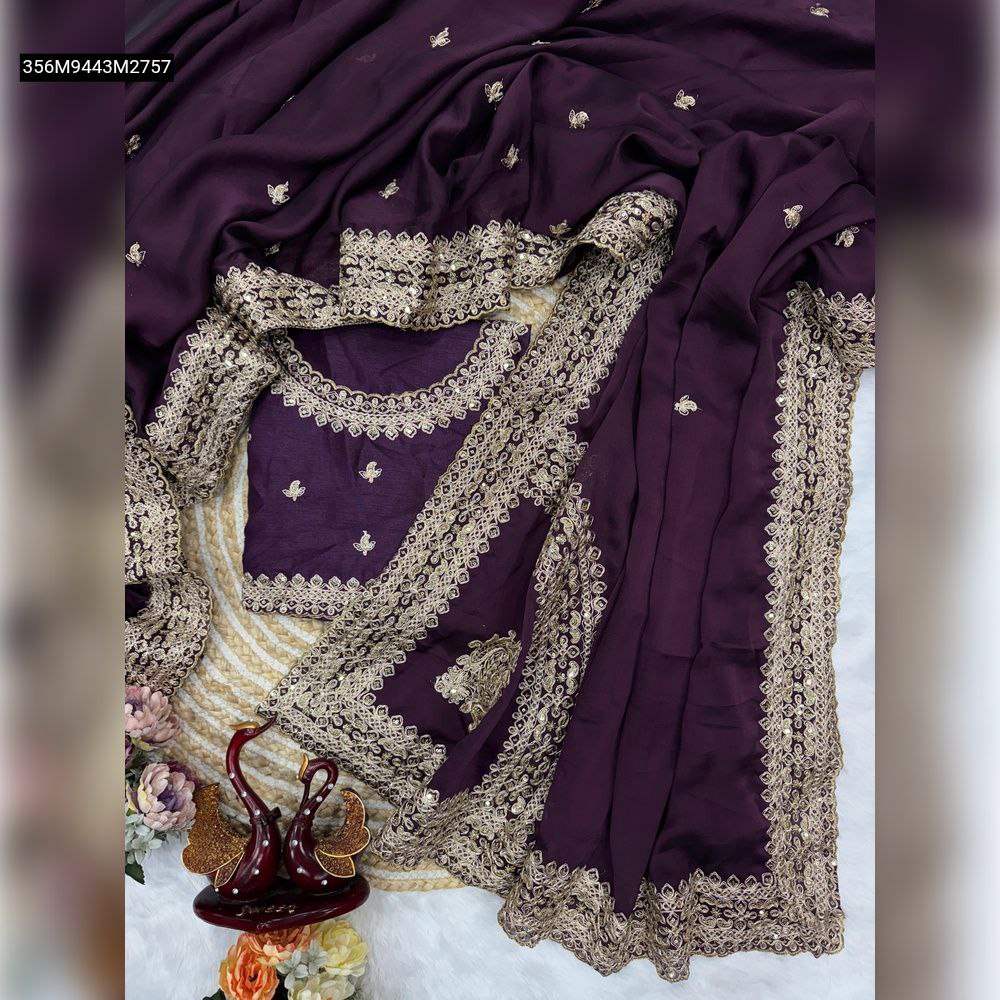 Overhead flat lay of a Deep Plum Rangoli silk saree with gold sequin and dori embroidery, featuring the matching unstitched blouse piece, set on a textured white and beige background with decorative swans.