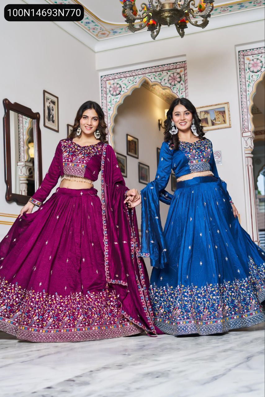 Two models in full flare deep purple and royal blue embroidered Vichitra silk lehenga choli, showcasing the opulent design and vibrant colors.
