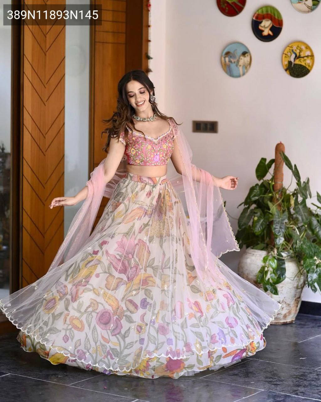 Model twirling gracefully in the TRENDBUY Floral Chinon Silk Lehenga Choli, emphasizing the grand 3.5-meter flare and soft net overlay of the lehenga skirt.