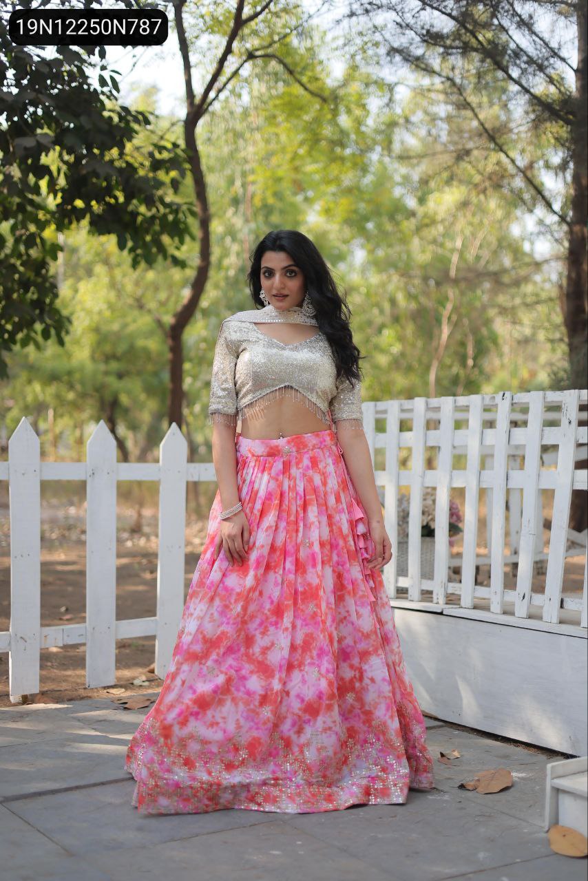 TRENDBUY model in full view wearing a stunning multi-color digital printed faux georgette lehenga choli with a silver sequin embroidered blouse, posing outdoors by a white fence.