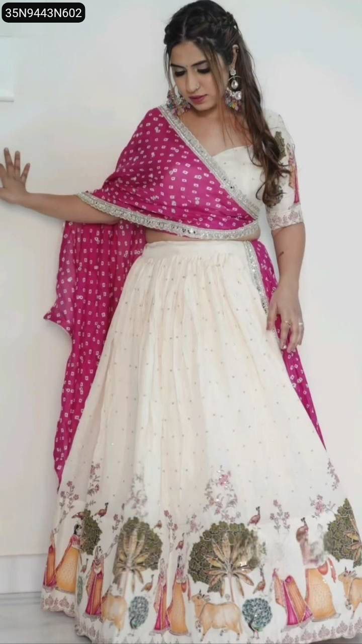 TRENDBUY model in a vibrant off-white Dola Silk lehenga choli set, featuring a full front view of the elaborate traditional print on the lehenga skirt and a fuchsia printed dupatta.