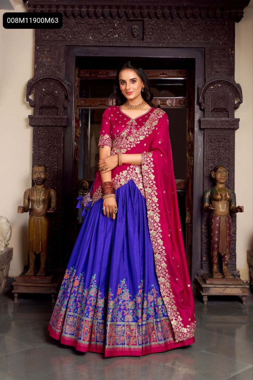 TRENDBUY woman in Fuchsia blouse and dupatta with Royal Blue printed foil work Tasar Silk lehenga, front view in traditional doorway.