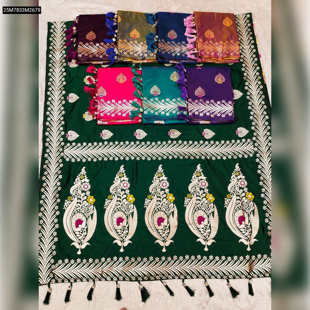 Close-up of intricate gold zari work with colorful Meenakari floral motifs on soft silk fabric