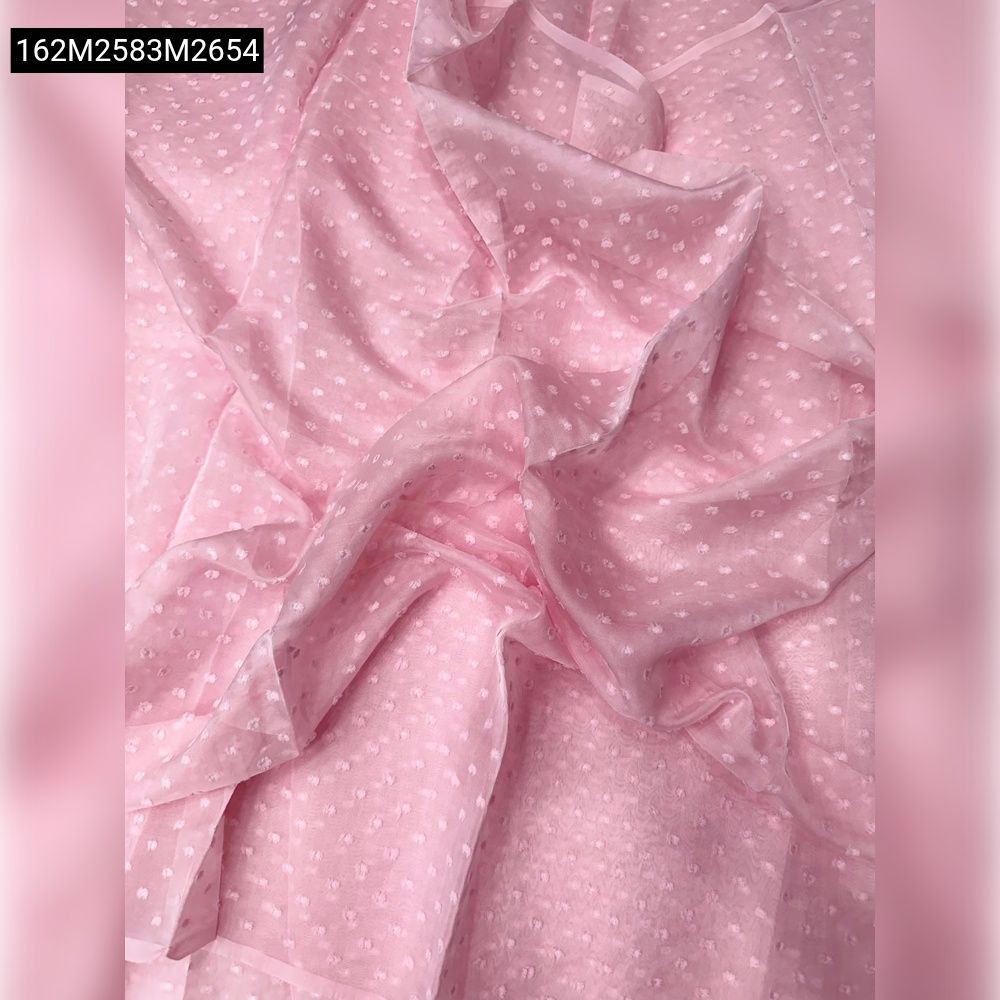 Draped close-up of light pink sheer chiffon fabric with 1000 butti dotted pattern.