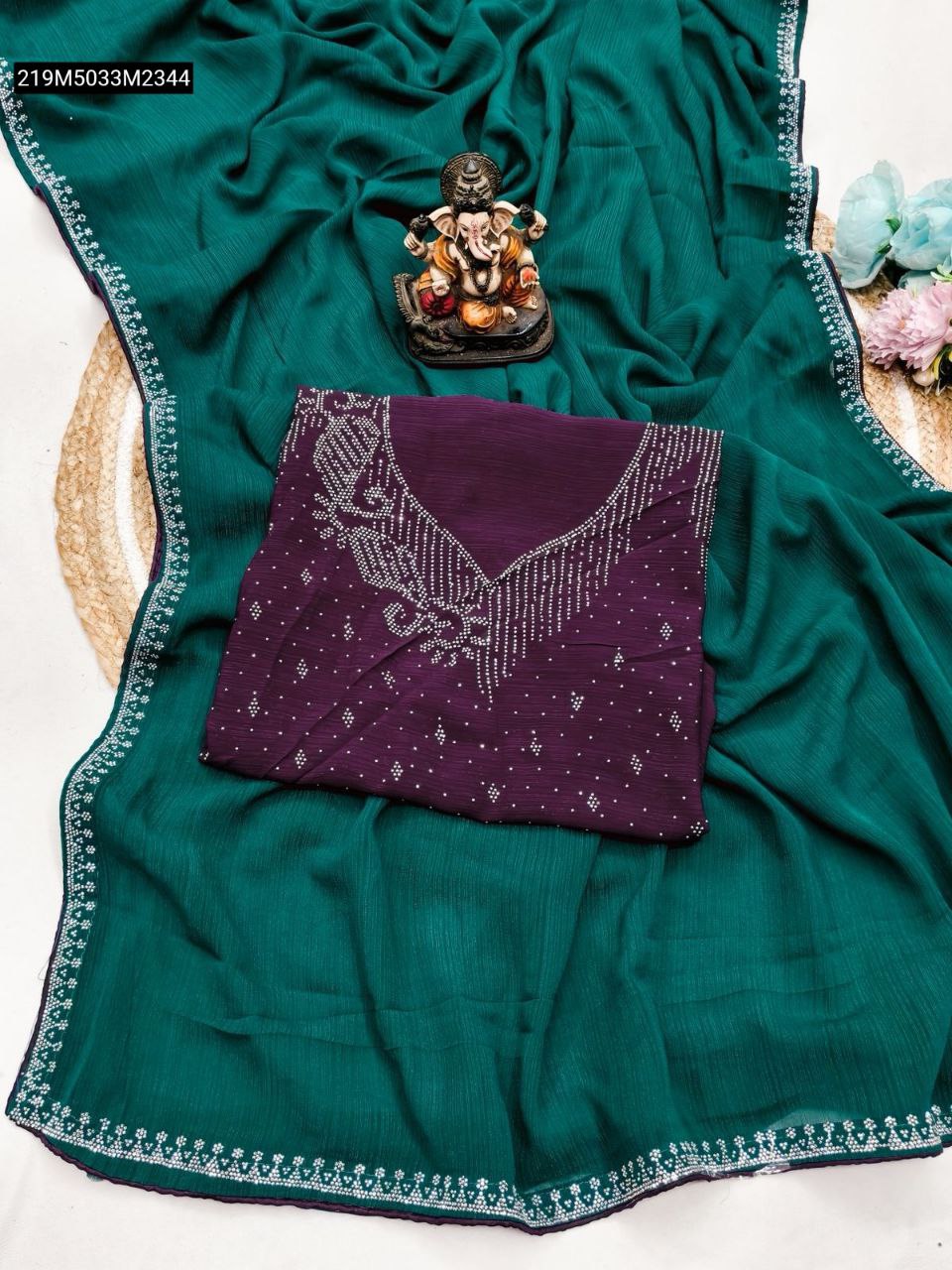 TRENDBUY Teal Chinnon Silk Saree with Purple Siroski Work Blouse Piece, flat lay on jute rug with Ganesha idol