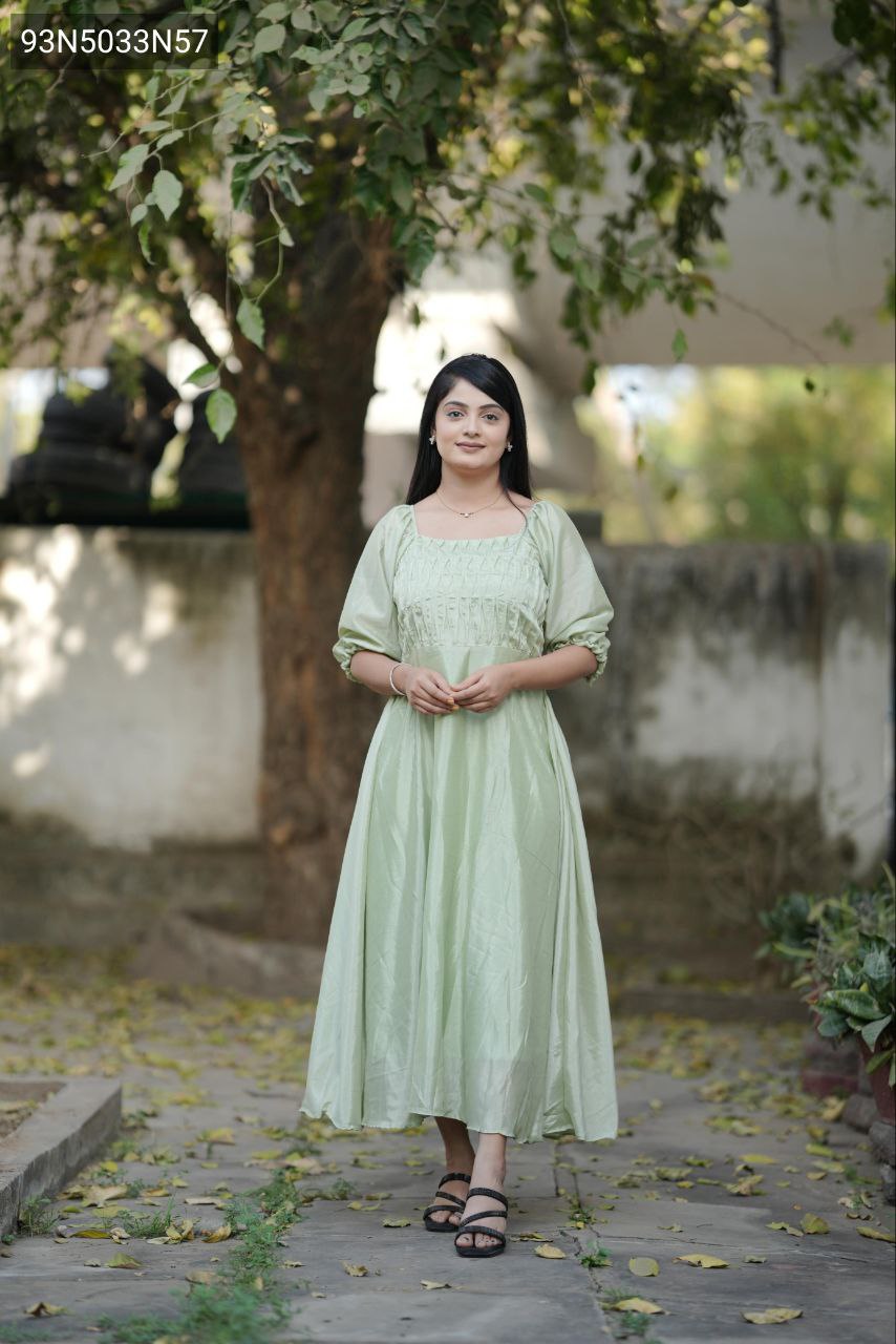 TRENDBUY Elegant Pista Green Chinon flared kurti, front view of model posing gracefully under a tree.