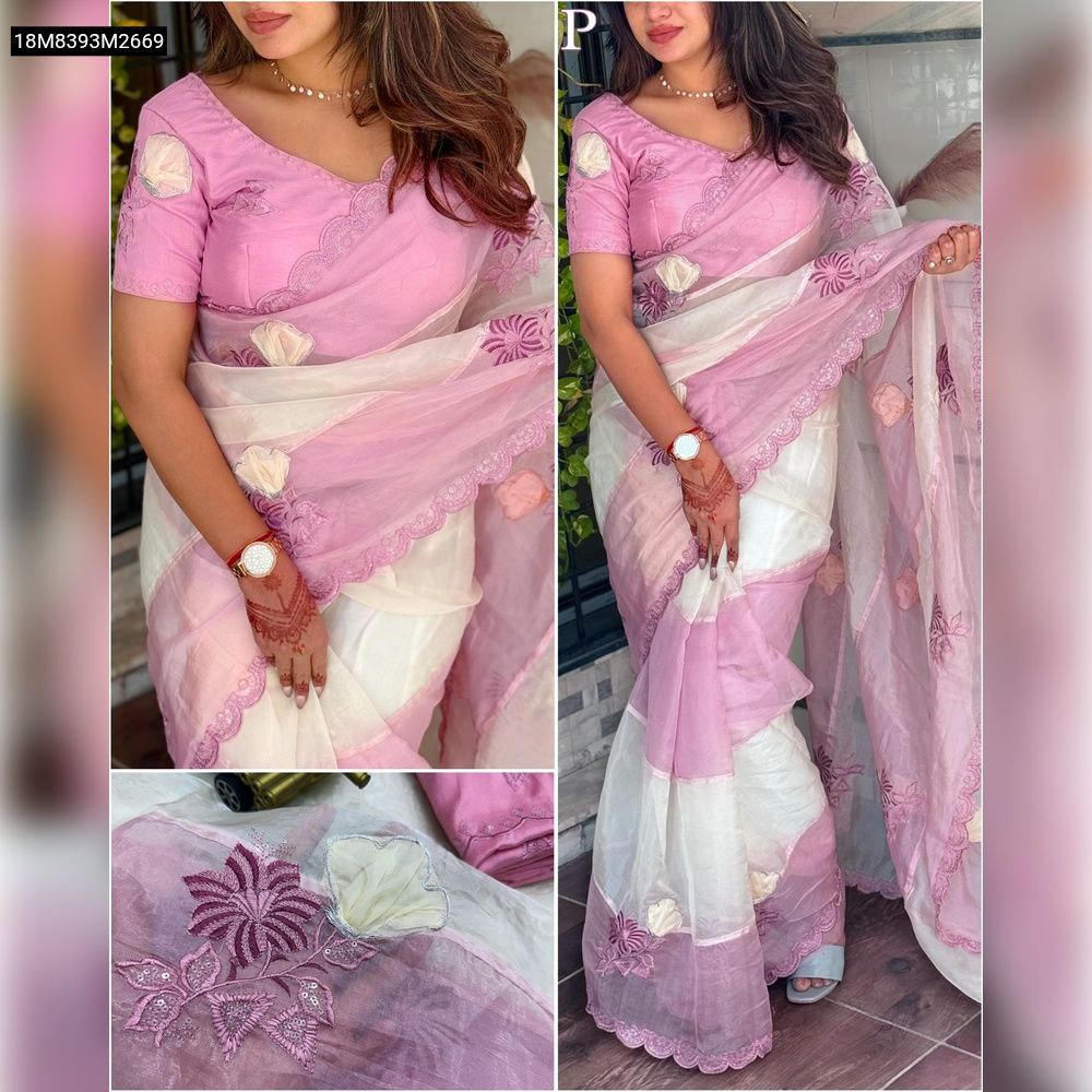 Full shot of a model elegantly draped in a pink crystal organza saree with white stripes and intricate floral embroidery, showcasing the outfit's full appeal.