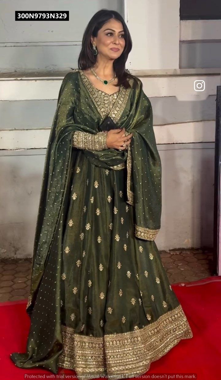 TRENDBUY model wearing an elegant dark green embroidered Cinon silk gown set with matching dupatta and emerald necklace.