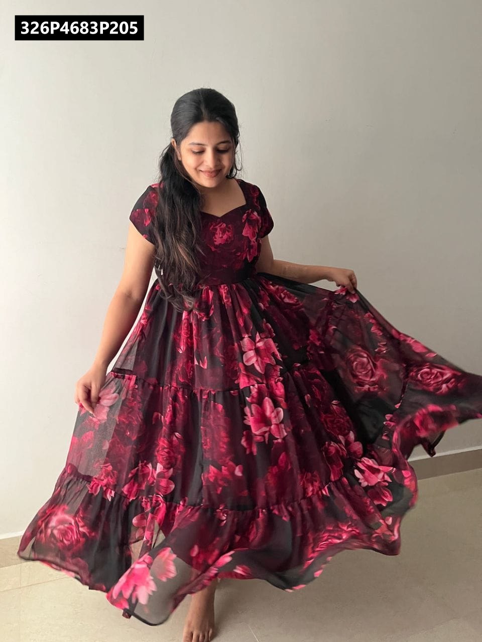 TRENDBUY model gracefully twirling in black and fuchsia floral 3-tier flare maxi dress.
