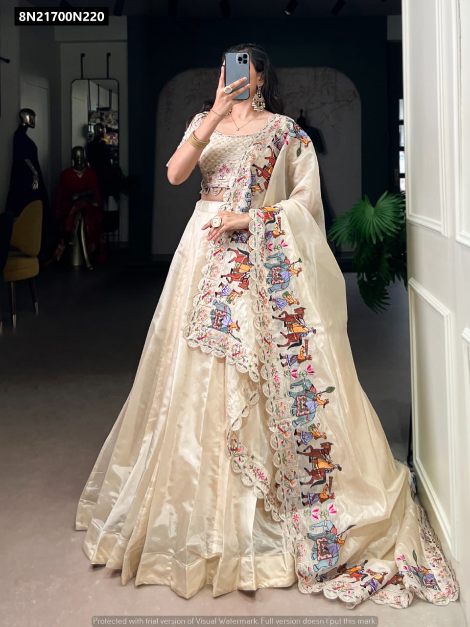 Main image: Elegant model gracefully posing in TRENDBUY Off-White Lehenga Choli, featuring a generous 5-meter flair and a dupatta with intricate multicolor embroidery.