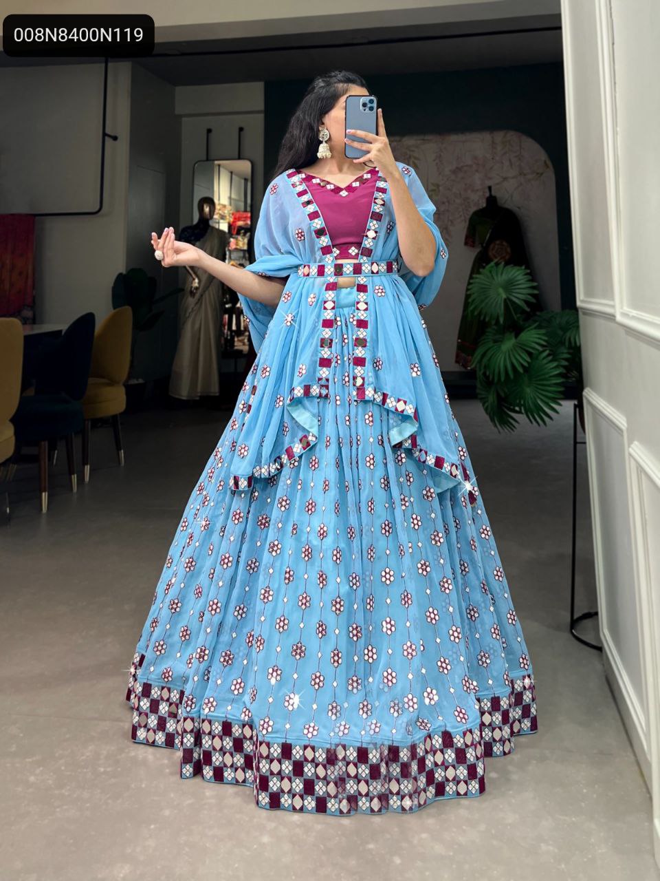 Full length view of a model wearing the TRENDBUY Sky Blue Georgette Lehenga Choli, showcasing detailed sequin and mirror embroidery, with a magenta blouse.