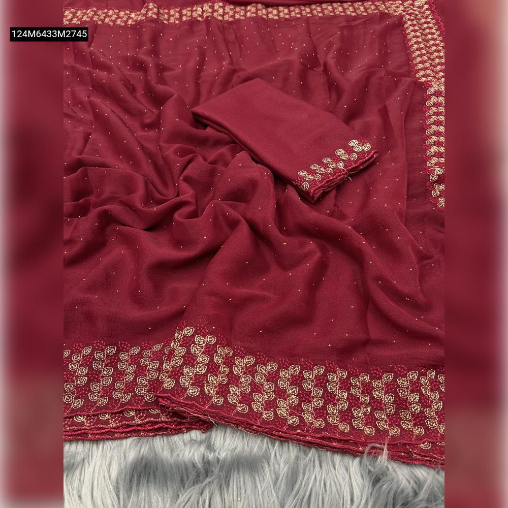 TRENDBUY Maroon Star Georgette saree with intricate gold embroidery on border and pallu, scattered embellishments, and matching contrast blouse piece, displayed on a grey fur background.