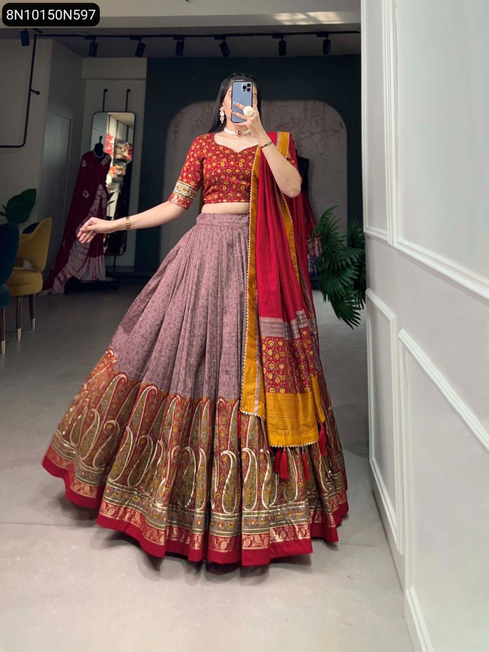 Full shot of a woman elegantly modeling a TRENDBUY red and multi-color printed Tussar silk lehenga choli set.