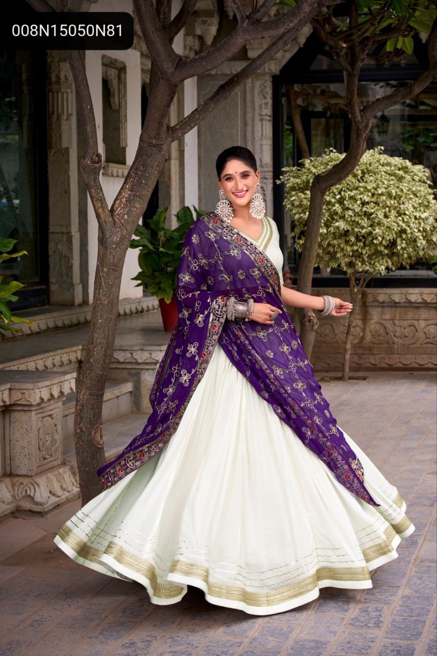 TRENDBUY model twirling in a stunning white rayon lehenga choli with an 8-meter flair, paired with a heavily embroidered purple georgette dupatta, set against a traditional backdrop.
