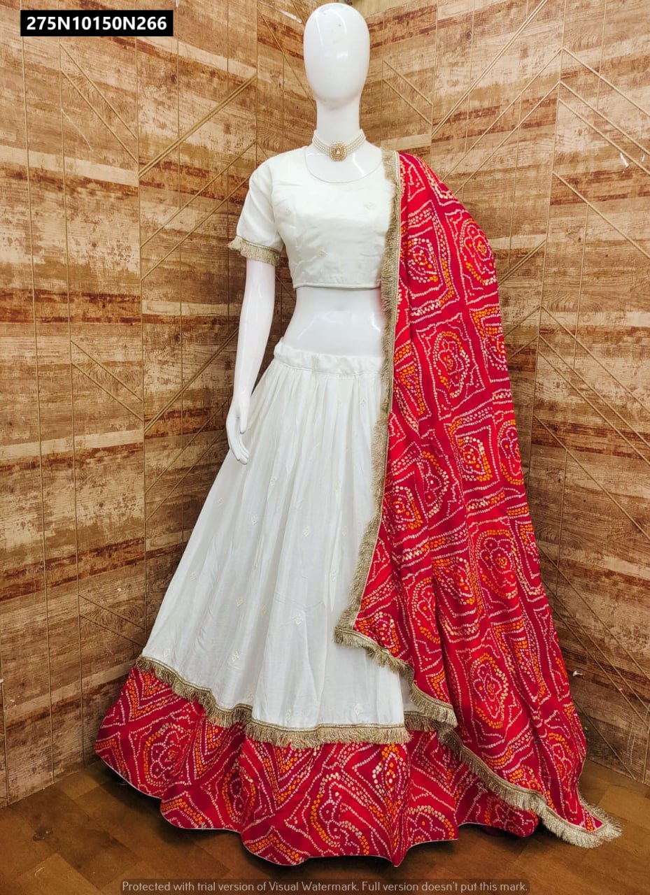 TRENDBUY White and Red Bandhani Lehenga Choli set on mannequin, featuring 4-meter flair and traditional gold fringe details.