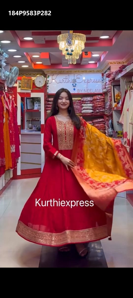 Full body shot of TRENDBUY model twirling in a red Anarkali kurti set, showcasing the expansive 3-meter flare and flowing Banarasi dupatta.