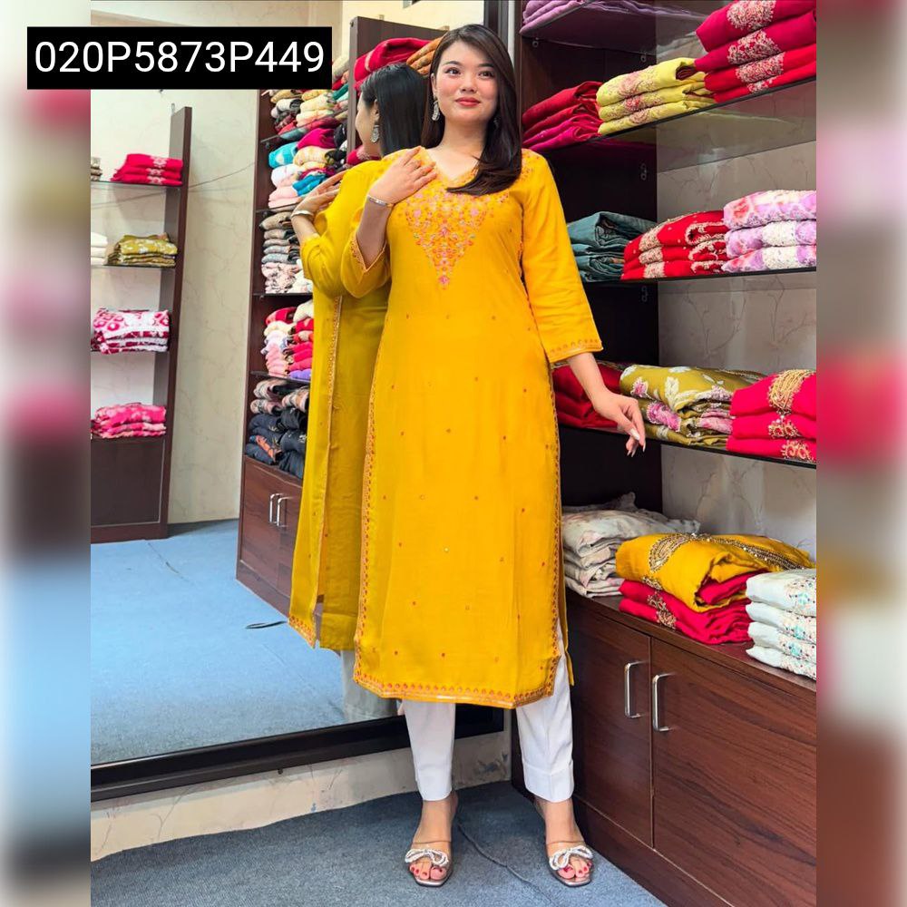 Full length model shot wearing a mustard yellow Banana Silk kurti set with white pants.