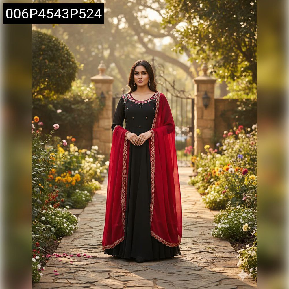 Full shot of a model standing on a garden path, wearing TRENDBUY's black georgette Anarkali gown with red dupatta, highlighting the ensemble.