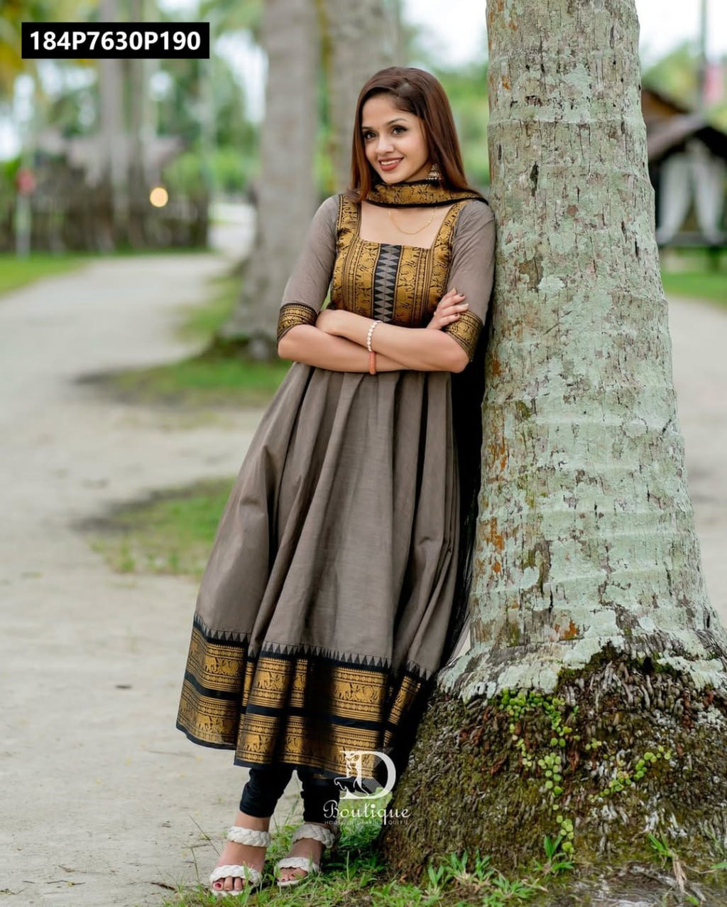 TRENDBUY Anarkali Kurti Set in taupe Chanderi silk with gold and black embroidery, model leaning against a tree.