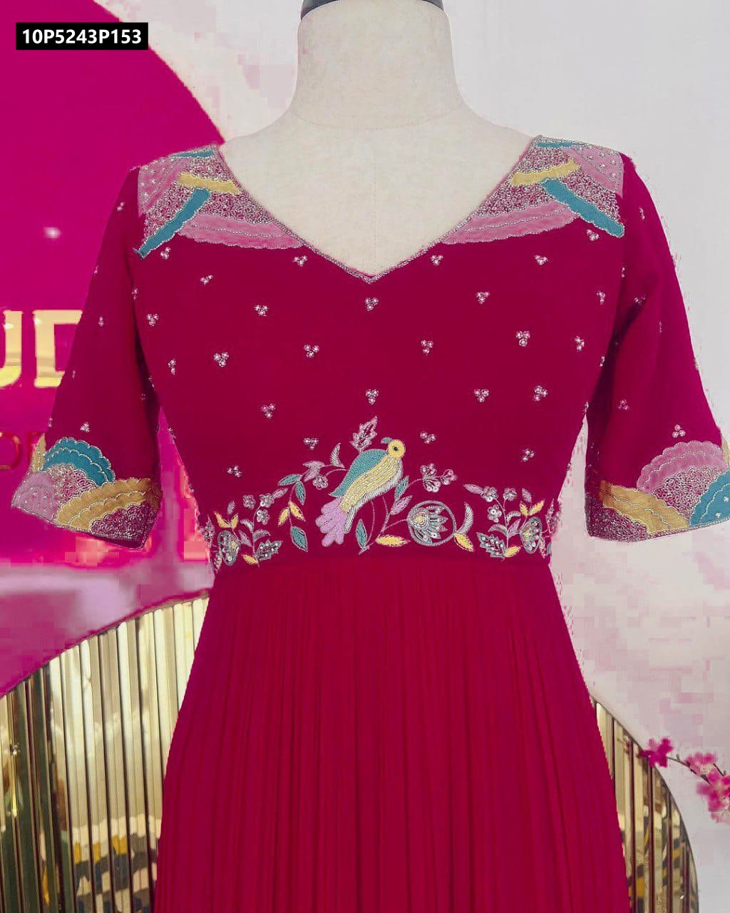 Close-up of intricate bird and floral embroidery on the bodice and sleeves