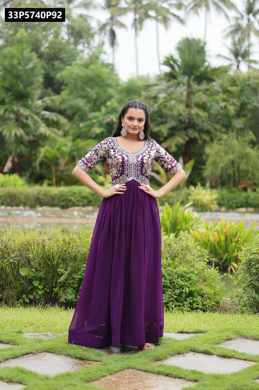 TRENDBUY women's purple embroidered faux blooming gown, full body shot, model posing elegantly outdoors with hands on hips, lush green background.