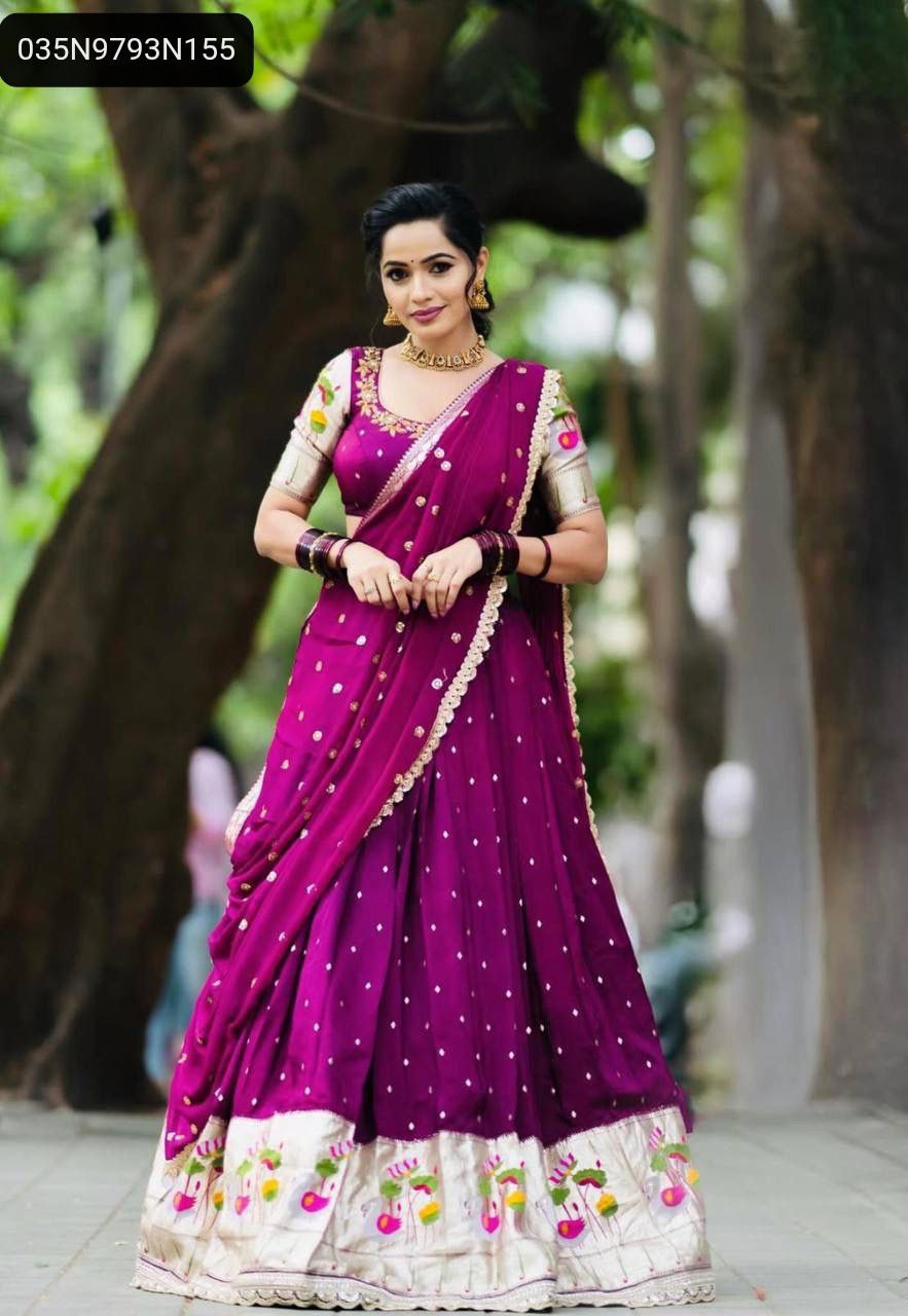 Full body shot of a model gracefully posing outdoors, wearing a vibrant purple TRENDBUY Georgette Lehenga Choli with intricate embroidery and sequence work, showing the flared lehenga and embellished border.