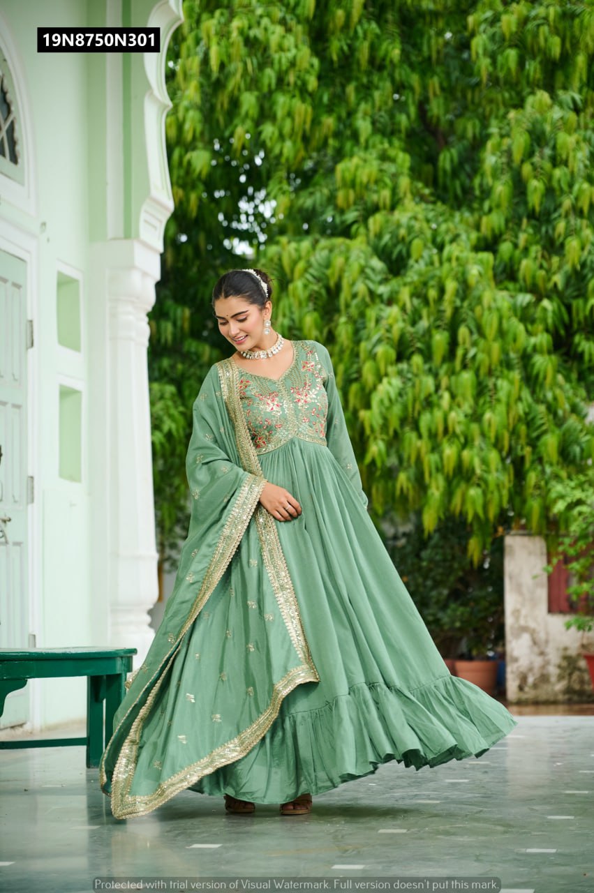 Full shot of model in Pista Green TRENDBUY Embroidered Gown with V-neck and full sleeves, gracefully posing outdoors.