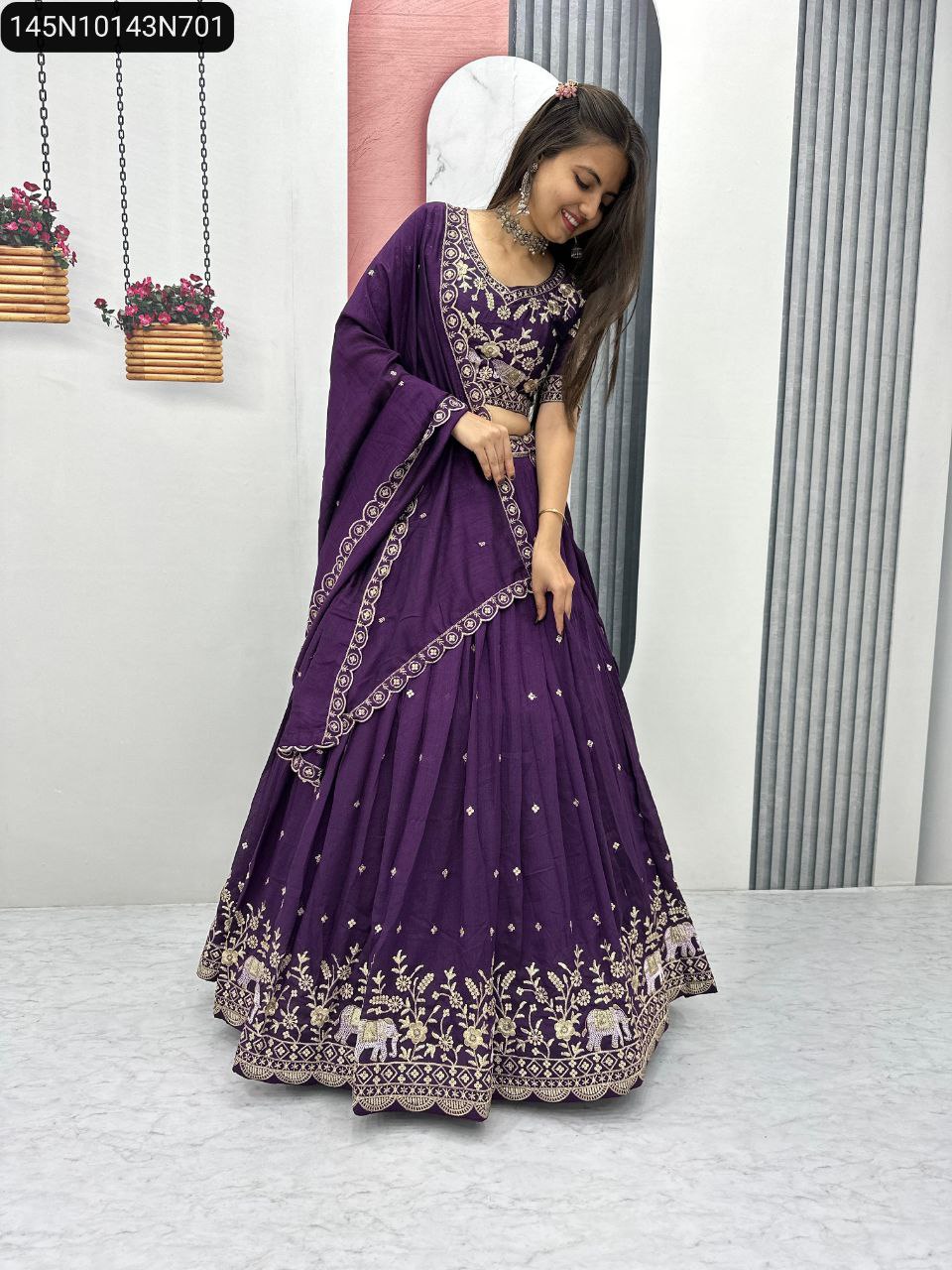 Full body shot of model elegantly posing in the TRENDBUY Purple Vichitra Silk Lehenga Choli, highlighting the voluminous flair and detailed border embroidery.