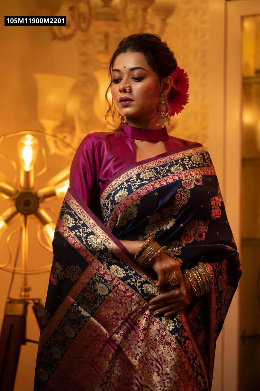 Model in a rich navy blue Banarasi silk saree with magenta blouse, showcasing intricate gold zari and meena floral patterns.