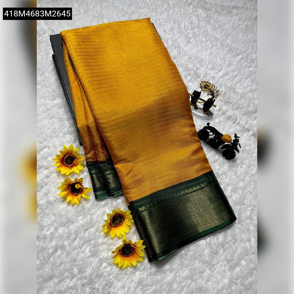 TRENDBUY Mustard Yellow Dola Silk Saree with a deep green woven border, elegantly folded on a white textured surface with sunflowers.