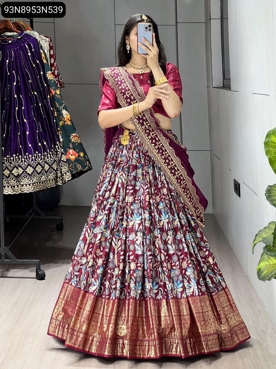 Full body shot of a model wearing the TRENDBUY maroon Kalamkari print Dola Silk lehenga choli, featuring a rich maroon base with intricate floral designs and a matching dupatta.