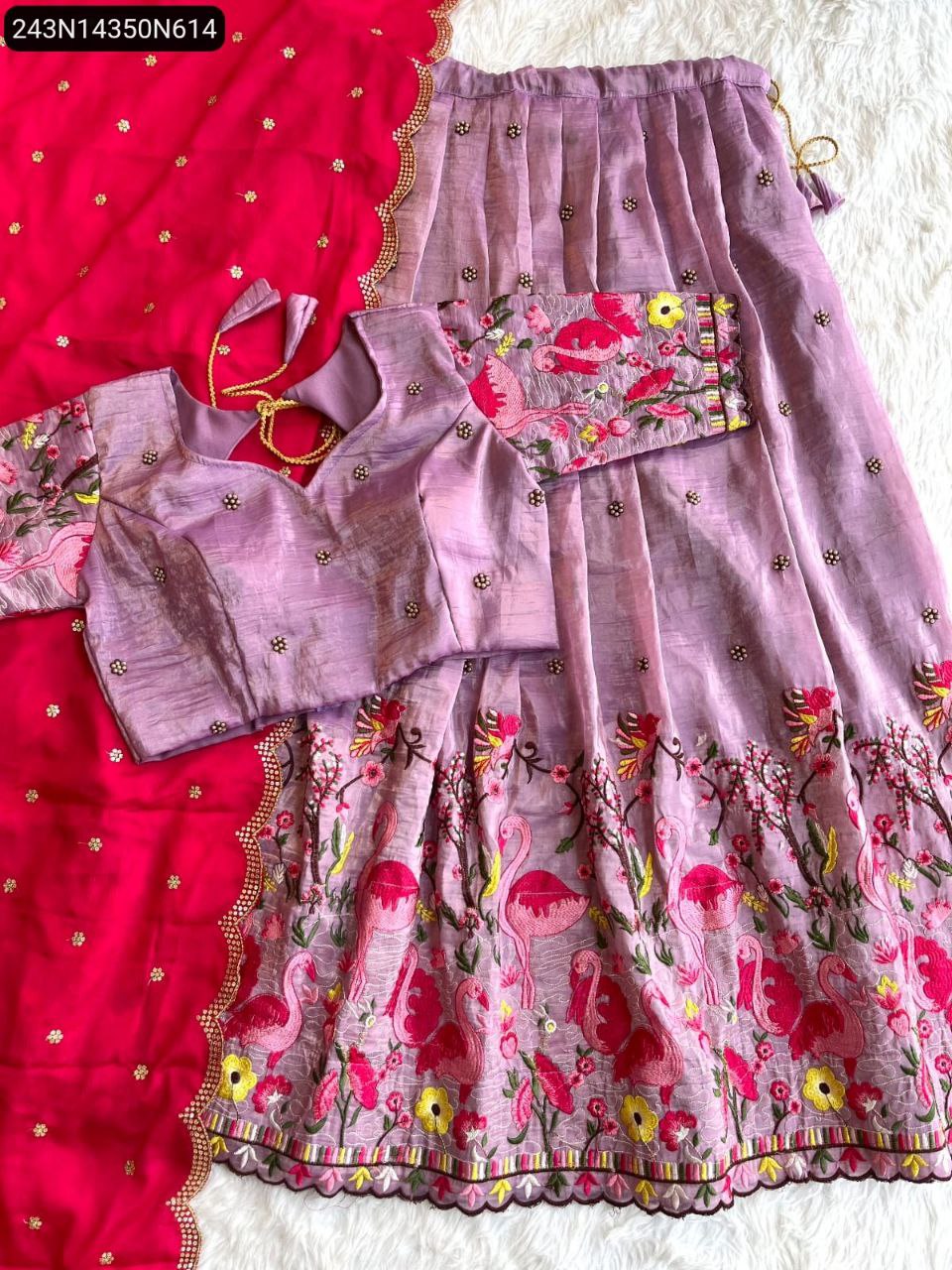 TRENDBUY Lavender fancy gold crush lehengha choli set with contrasting pink dupatta, featuring vibrant flamingo and floral embroidery, flat lay.