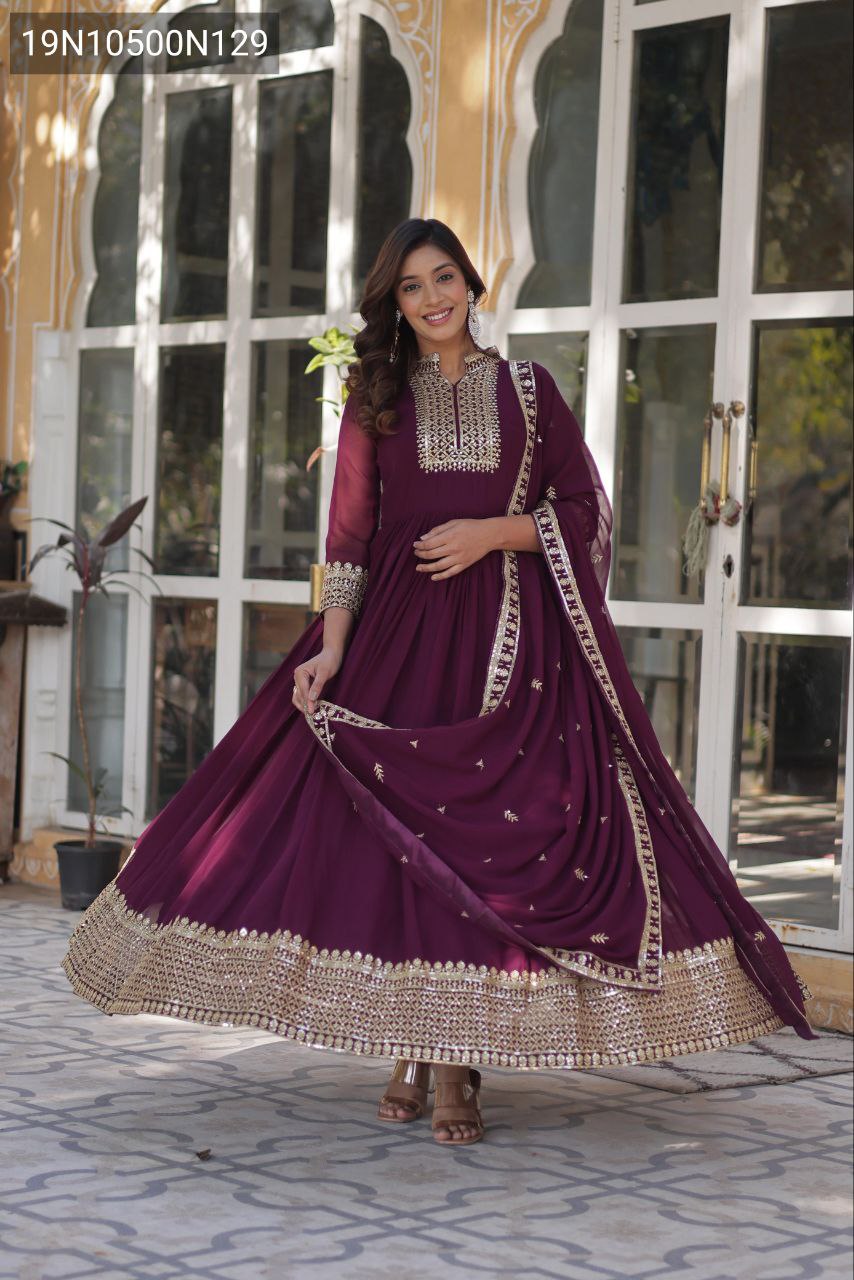 Smiling model in a New Wine Anarkali Gown, displaying the full volume and shimmering gold embroidery on the hem and dupatta.