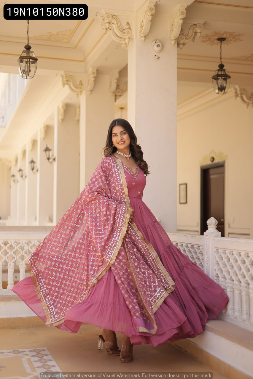 Model gracefully twirling in an Onion pink tiered gown, showcasing the 15 MTR flair and embroidered dupatta on a beautiful balcony