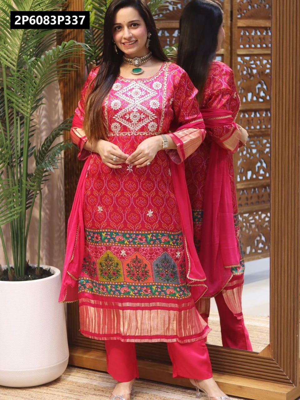 Full body shot of a smiling model showcasing the elegant TRENDBUY pink Masleen kurti set with Bandhani print, embroidery, and solid pants.