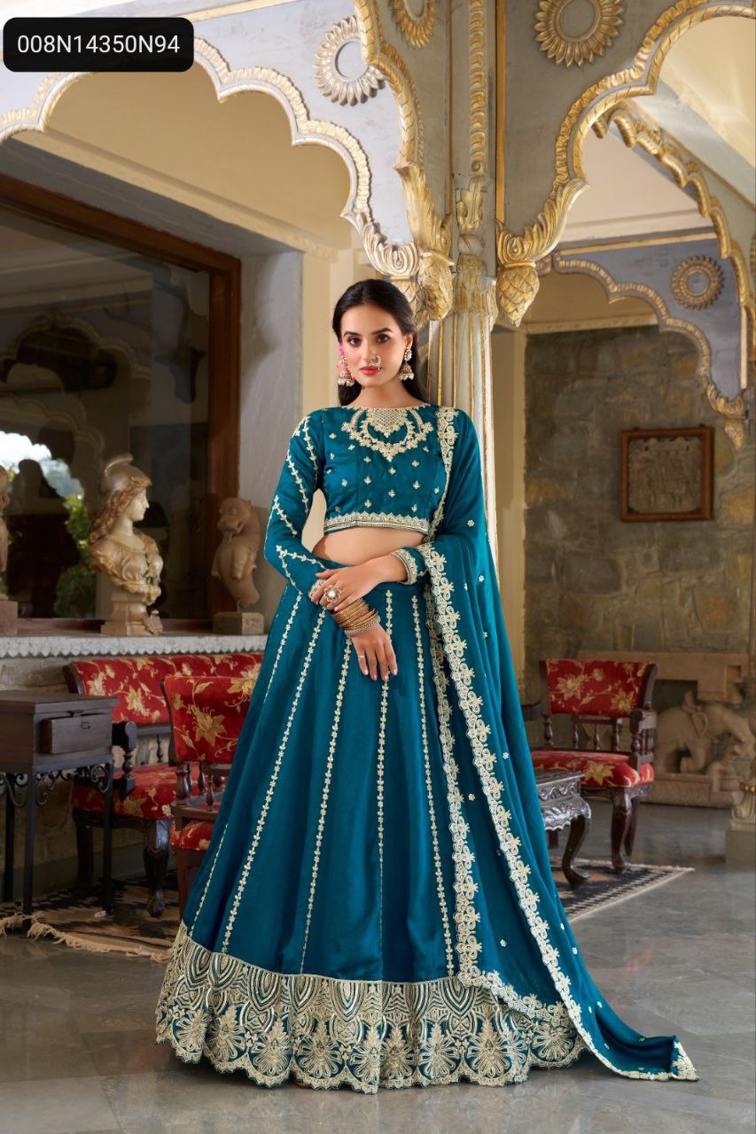 Front view of a woman wearing a stunning TRENDBUY Firozi Vichitra Silk Lehenga Choli, featuring elaborate gold sequin and thread embroidery on the blouse and lehenga, posed elegantly in a palatial setting.