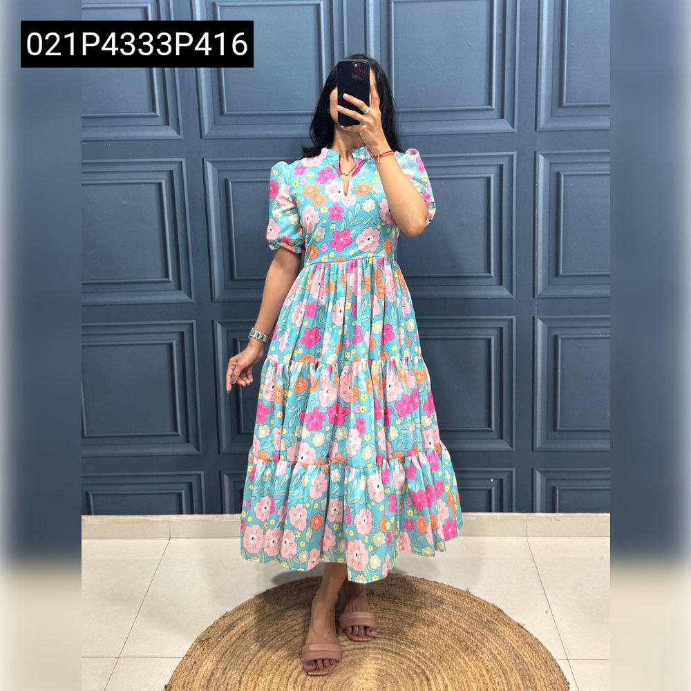 Full body shot of a model wearing a Teal Floral TRENDBUY muslin cotton tiered midi dress, standing on a jute mat.