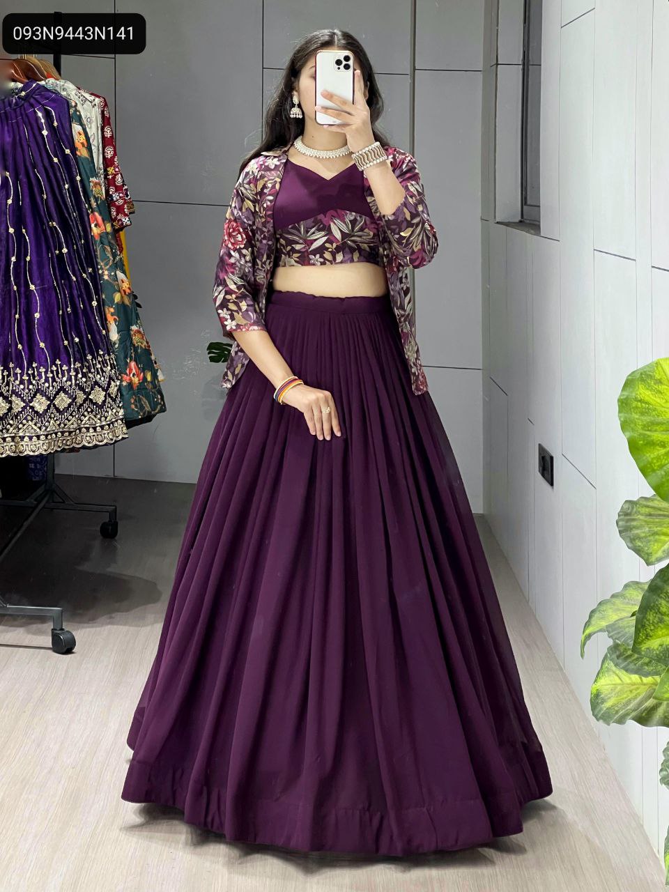 Full body shot of model in deep purple georgette lehenga with multi-colored floral foil print koti, front view, posing elegantly.