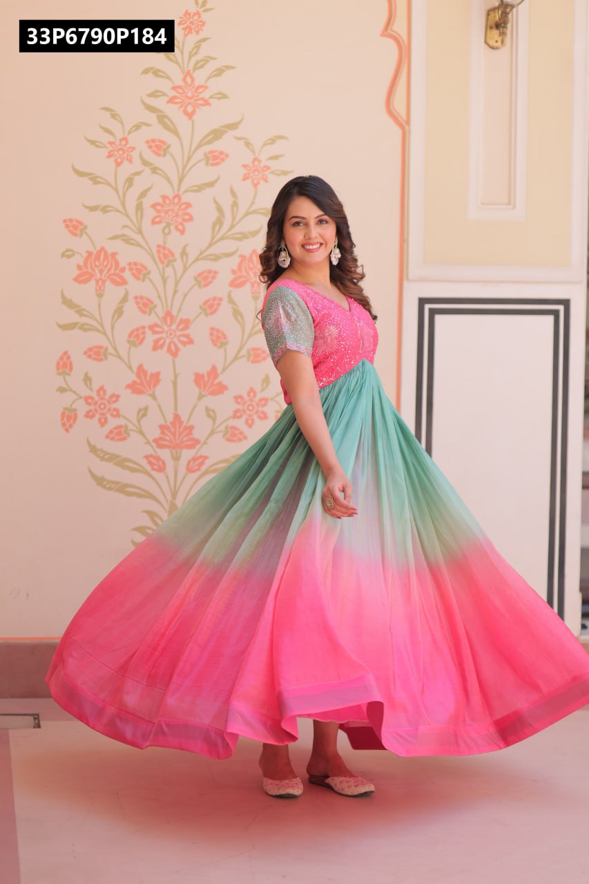 Full shot of model smiling and twirling in a pink and mint green ombre Gold Crush gown with beads embroidery, V-neck, and half sleeves.