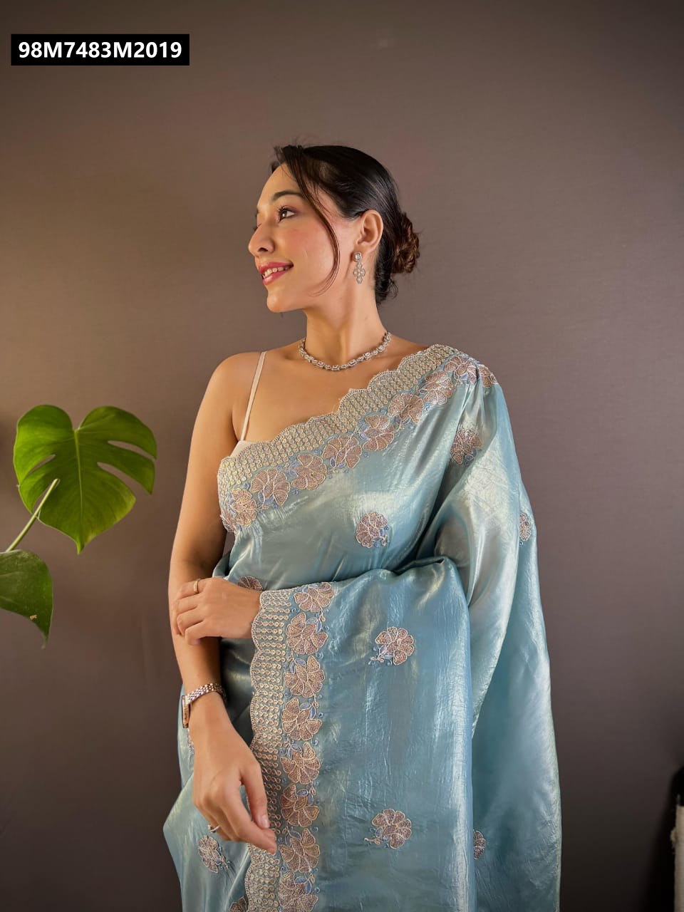 TRENDBUY Gold Crush Saree in Sky Blue, model looking sideways, showcasing C-Pallu embroidery.