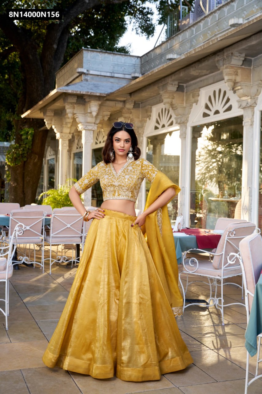 TRENDBUY Golden Goldie Silk Lehenga Choli Set with sequin embroidery, worn by a model posing confidently outdoors against a palace backdrop.