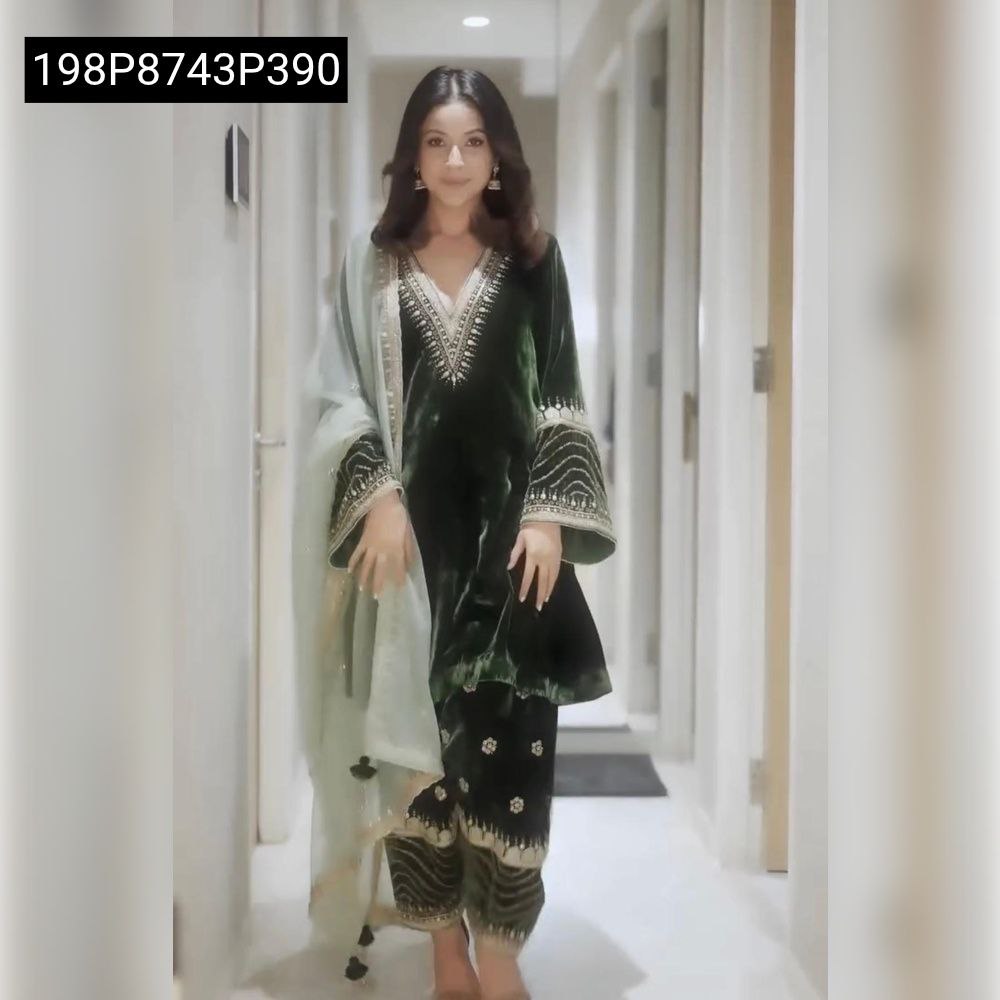 Full body shot of a model confidently walking, wearing the TRENDBUY green embroidered viscose velvet silk kurti bottom pair with a flowing light green dupatta.